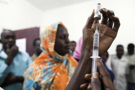 Staff members of the Teaching Hospital receive the first vaccination treatment for yellow fever in El Geneina, West Darfur in this November 14, 2012 handout.    REUTERS/Albert Gonzalez Farran/UNAMID/Handout