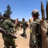 Fighters of the Syria Democratic Forces (SDF) carry their weapons as they walk in the western rural area of Manbij, in Aleppo Governorate, Syria, June 13, 2016. REUTERS/Rodi Said