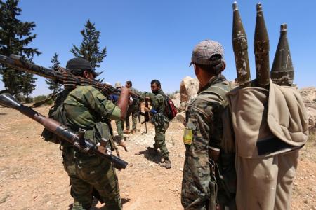 Fighters of the Syria Democratic Forces (SDF) carry their weapons as they walk in the western rural area of Manbij, in Aleppo Governorate, Syria, June 13, 2016. REUTERS/Rodi Said