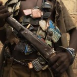 An anti-balaka militiaman poses for a photograph on the outskirts of the capital of the Central African Republic Bangui January 15, 2014. REUTERS/Siegfried Modola