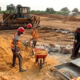 Labourers mix cement at the site of a new port to be built in the oil-producing Angolan exclave of Cabinda, June 11, 2016. Picture taken June 11, 2016.  REUTERS/Ed Cropley
