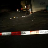 A cameraman films at the scene where a man was shot dead by the police after attacking passengers on a train with an axe near the city of Wuerzburg, Germany July 19, 2016.  REUTERS/Kai Pfaffenbach