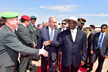 Israeli Prime Minister Benjamin Netanyahu (C) introduces members of his delegation to Uganda's President Yoweri Museveni after arriving to commemorate the 40th anniversary of Operation Entebbe at the Entebbe airport in Uganda, July 4, 2016. Presidential Press Unit/Handout via REUTERS