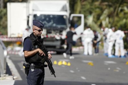 French police secure the area as the investigation continues at the scene near the heavy truck that ran into a crowd at high speed killing scores who were celebrating the Bastille Day July 14 national holiday on the Promenade des Anglais in Nice, France, July 15, 2016.    REUTERS/Eric Gaillard