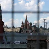 A view through a construction fence shows the Kremlin towers and St. Basil's Cathedral on a hot summer day in central Moscow, Russia, July 1, 2016.  REUTERS/Maxim Zmeyev/File Photo