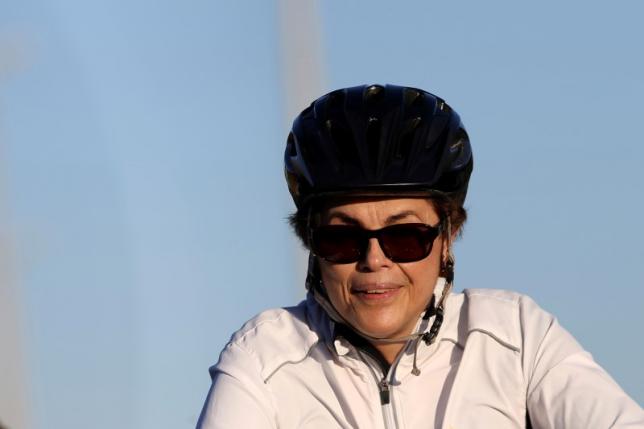 Brazil's suspended President Dilma Rousseff rides her bicycle near the Alvorada Palace in Brasilia, Brazil, August 3, 2016. REUTERS/Adriano Machado