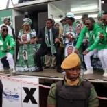 Edgar Lungu (C, in black suit), leader of the Patriotic Front party (PF), dances before addressing his supporters during a rally ahead of Thursday's presidential elections in the capital, Lusaka, Zambia August 10, 2016. REUTERS/Jean Serge Mandela
