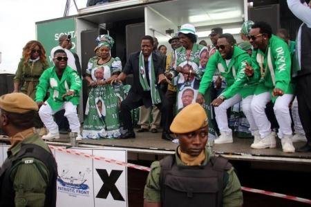 Edgar Lungu (C, in black suit), leader of the Patriotic Front party (PF), dances before addressing his supporters during a rally ahead of Thursday's presidential elections in the capital, Lusaka, Zambia August 10, 2016. REUTERS/Jean Serge Mandela