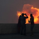 People watch the wildfires at Funchal, Madeira island, Portugal. REUTERS/Duarte Sa