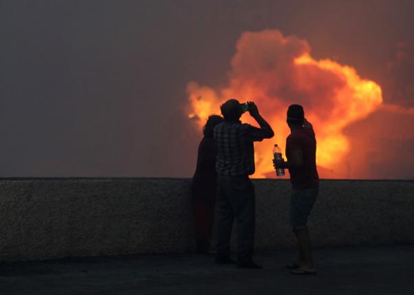 People watch the wildfires at Funchal, Madeira island, Portugal. REUTERS/Duarte Sa
