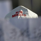 A family member of a passenger onboard Malaysia Airlines flight MH370 which went missing in 2014 holds a banner during a gathering in front of the Malaysian Embassy on the second anniversary of the disappearance of MH370, in Beijing, China, March 8, 2016.   REUTERS/Damir Sagolj - RTS9SC3