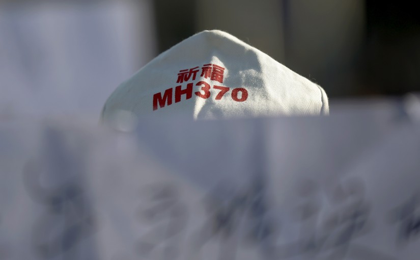 A family member of a passenger onboard Malaysia Airlines flight MH370 which went missing in 2014 holds a banner during a gathering in front of the Malaysian Embassy on the second anniversary of the disappearance of MH370, in Beijing, China, March 8, 2016.   REUTERS/Damir Sagolj - RTS9SC3