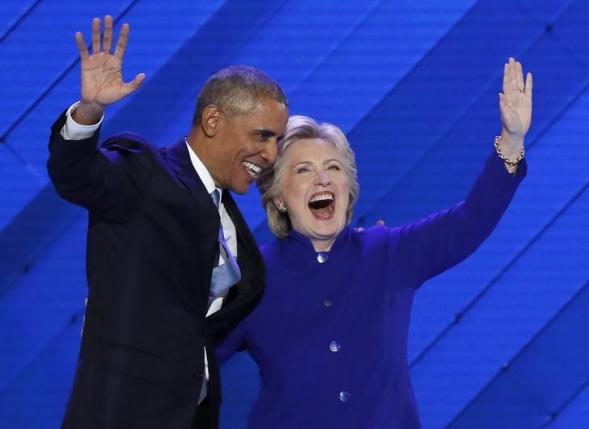 U.S. President Barack Obama and Democratic presidential nominee Hillary Clinton appear onstage together after his speech on the third night at the Democratic National Convention in Philadelphia, Pennsylvania, U.S. July 27, 2016.  REUTERS/Mike Segar