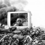 A young boy is playing behind a discarded TV frame at the Hulene dump in Maputo. Many electronic items are sent to the dump every day, and the people who live and work on the site recycle them for reuse and resale on the black market. They also have to navigate the huge number of items which will not see reuse. There is limited regulatory oversight on e-waste processing in Mozambique, and e-waste is causing serious health and pollution problems in the area.