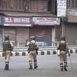 Indian paramilitary soldiers patrol deserted street during curfew in Srinagar, Indian controlled Kashmir, Monday, July 11, 2016. Indian authorities are struggling to contain protests by tens of thousands of Kashmiris angry after 20 people were killed in weekend demonstrations called after troops killed a top anti-India rebel leader. (AP Photo/Dar Yasin)