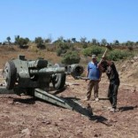 Rebel fighters secure a weapon in Jubata al-Khashab, in Quneitra countryside, Syria September 11, 2016. REUTERS/Alaa Al-Faqir