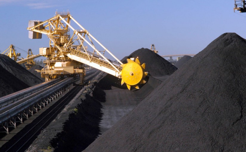 A bucketwheel reclaimer rides on rails between huge coal stockpiles at the Port Waratah coal loading facility in Newcastle, Australia Tuesday, June 1, 2004. Australian exports rose to the second highest on record in October, narrowing the trade deficit more than expected, as miners including Portman Ltd. and BHP Billiton earned more from commodity shipments to China. Photographer: Gillianne Tedder/Bloomberg News
