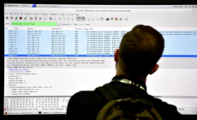 An attendee looks at a monitor at the Parsons booth during the 2016 Black Hat cyber-security conference in Las Vegas, Nevada, U.S. August 3, 2016.  REUTERS/David Becker