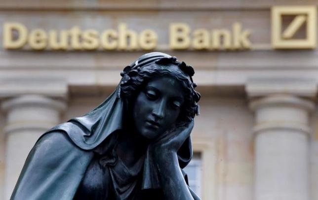 A statue is seen next to the logo of Germany's Deutsche Bank in Frankfurt, Germany, January 26, 2016.    REUTERS/Kai Pfaffenbach/File Photo