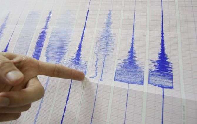 An official points to strong earthquake markings on Seismogram recordings at the Seismology Center in Taipei, Taiwan, late Thursday, Oct. 31, 2013. The U.S. Geological Survey said the earthquake struck at 8:02 p.m. and measured magnitude 6.3. It was centered in a remote mountainous area 45 kilometers (28 miles) south-southwest of the coastal city of Hualian at a depth of just 12 kilometers (7.5 miles). There were no immediate reports of serious damage or casualties. (AP Photo/Wally Santana) Taiwan Earthquake