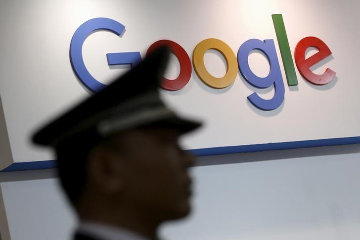 A security guard keeps watch as he walks past a logo of Google in Shanghai, China, April 21, 2016. REUTERS/Aly Song/File Photo