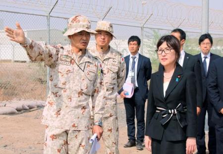 Japan's Defence Minister Tomomi Inada (front, R) is briefed by senior Self-Defense Forces personnel about their anti-piracy mission off Somalia, in Djibouti, August 15, 2016. Picture taken August 15, 2016. Mandatory credit Kyodo/via