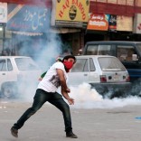 A protester throws stones at police during clashes in Rawalpindi, Pakistan October 28,  2016. REUTERS/Caren Firouz