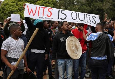 Students chant slogans during clashes with the South African police at Johannesburg's University of the Witwatersrand, South Africa, October 4, 2016. REUTERS/Siphiwe Sibeko