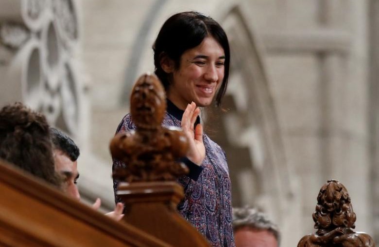 Nadia Murad Basee Taha, United Nations Goodwill Ambassador for the Dignity of Survivors of Human Trafficking, waves while being recognized by the Speaker in the House of Commons on Parliament Hill in Ottawa, Canada, October 25, 2016. REUTERS/Chris Wattie - RTX2QF62
