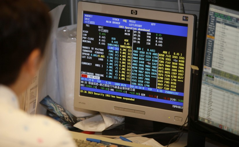 epa03582888 A broker looks at his screen on the trading floor of the Hong Kong Stock Exchange on the first day of trading in the Chinese lunar new year of the snake, Hong Kong, China, 14 February 2013.  EPA/ALEX HOFFORD