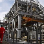 Oil workers walk through pipe installations on a tanker at Bonga off-shore oil field outside Lagos,  file. NIGERIA-BONGA/.
