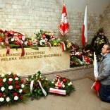 A man prays in front of the sarcophagus of the late President Lech Kaczynski during an event commemorating the first year anniversary of his funeral in Krakow April 18, 2011.   REUTERS/Kacper Pempel