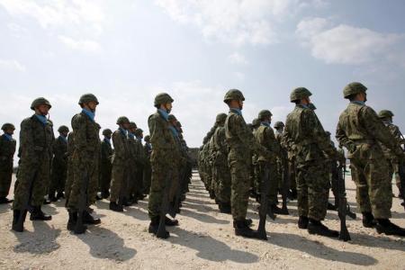 Soldiers of Japan's Self Defence Force stand at attention during the opening ceremony of a military base on the island of Yonaguni in the Okinawa prefecture, March 28, 2016.     REUTERS/Nobuhiro Kubo