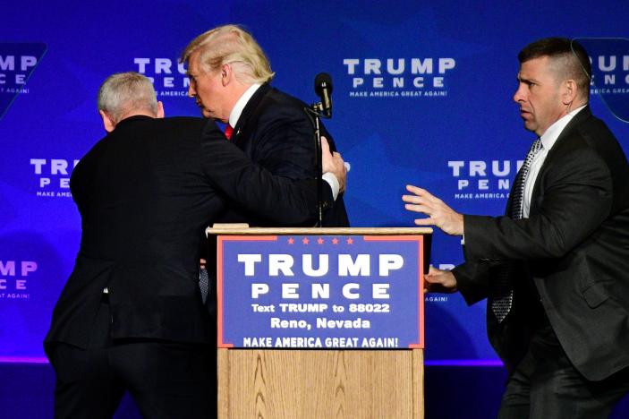 U.S. Republican presidential nominee Donald Trump is hustled off the stage by security agents after a perceived threat in the crowd, at a campaign rally in Reno, Nevada, U.S. November 5, 2016. REUTERS/Steven Styles
