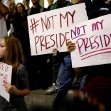 A girl joins demonstrators to protest outside of City Hall following the election of Republican Donald Trump as President of the United States in downtown Los Angeles, California November 10, 2016. REUTERS/Patrick T. Fallon