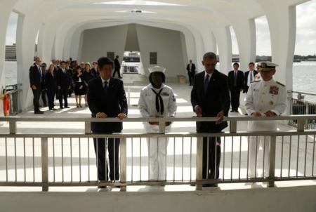 U.S. President Barack Obama (2ndR) releases flower petals following a wreath-laying ceremony with Japanese Prime Minister Shinzo Abe (L) aboard the USS Arizona Memorial at Pearl Harbor, Hawaii, U.S., December 27, 2016. REUTERS/Kevin Lamarque