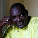 The new president of Gambia, Adama Barrow smiles as he makes a call at his home in Yarambamba, West Coast Region, Gambia December 3, 2016. REUTERS/ Thierry Gouegnon