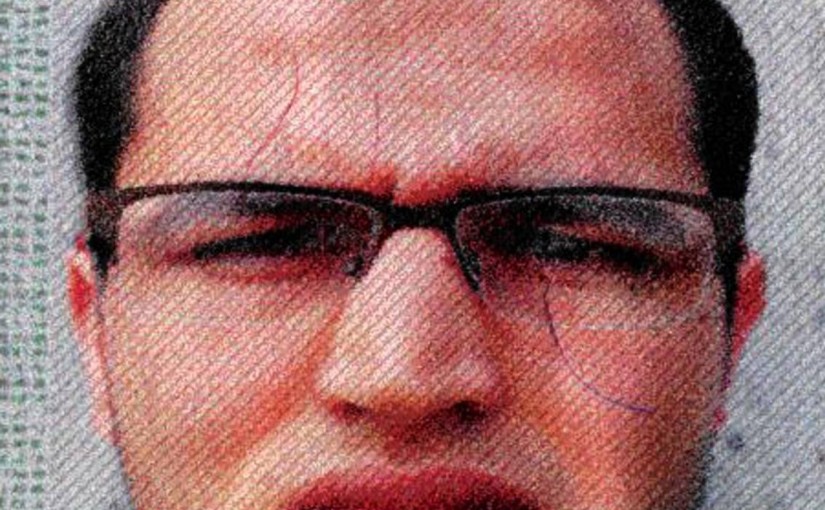 The photo issued by German federal police on Wednesday, Dec. 21, 2016 shows 24-year-old Tunisian Anis Amri on a photo that was used on the documents found in the truck. He is suspected of being involved in the fatal attack on the Christmas market in Berlin on Dec. 19, 2016. German authorities are offering a reward of up to 100,000 euros (US$ 105,000) for the arrest of the Tunisian. (German police via AP)