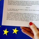 Article 50 of the EU's Lisbon Treaty that deals with the mechanism for departure is pictured near an EU flag following Britain's referendum results to leave the European Union, in this photo illustration taken in Brussels, Belgium, June 24, 2016. REUTERS/Francois Lenoir/Illustration/File Photo