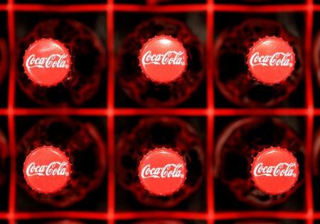 Logos are seen on Coca-Cola bottles in Zurich, February 16, 2011. REUTERS/Christian Hartmann/File Photo
