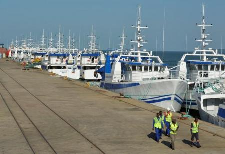 Security guards patrol past the EMATUM fishing fleet docked in Maputo, Mozambique. REUTERS/Grant Lee Neuenburg