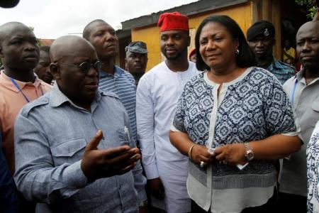 Ghanaian presidential candidate Nana Akufo-Addo (L) of the opposition New Patriotic Party (NPP) talks next to his wife Rebecca after casting his vote at a polling station in Kibi, Ghana December 7, 2016. REUTERS/Luc Gnago