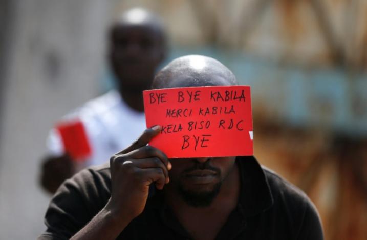 A Congolese opposition party supporter displays a red card against President Joseph Kabila in Kinshasa, Democratic Republic of Congo December 19, 2016. REUTERS/Thomas Mukoya