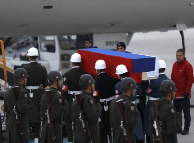 Flag-wrapped coffin of late Russian Ambassador to Turkey Andrei Karlov is carried to a plane during a ceremony at Esenboga airport in Ankara, Turkey, December 20, 2016. REUTERS/Umit Bektas
