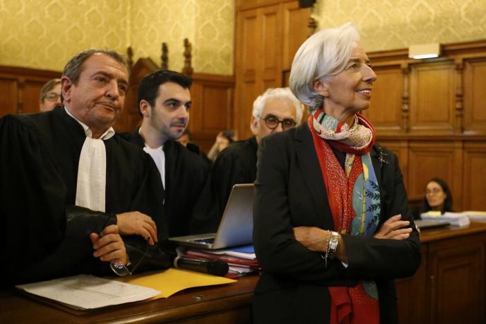 Managing Director of the International Monetary Fund (IMF) Christine Lagarde stands near her lawyer Patrick Maisonneuve (L) before the start of her trial about a state payout in 2008 to a French businessman, at the courts in Paris, France, December 12, 2016.   REUTERS/Charles Platiau