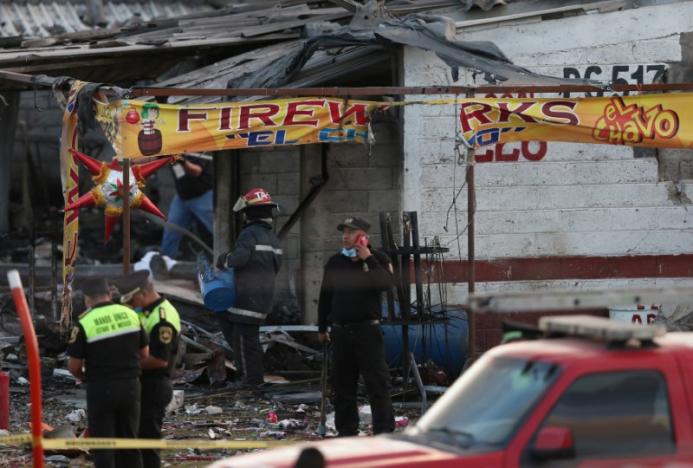 Firefighters and rescue personnel stand near a destroyed house after an explosion at the San Pablito fireworks market outside the Mexican capital on Tuesday, in Tultepec, Mexico, December 20, 2016. REUTERS/Edgard Garrido