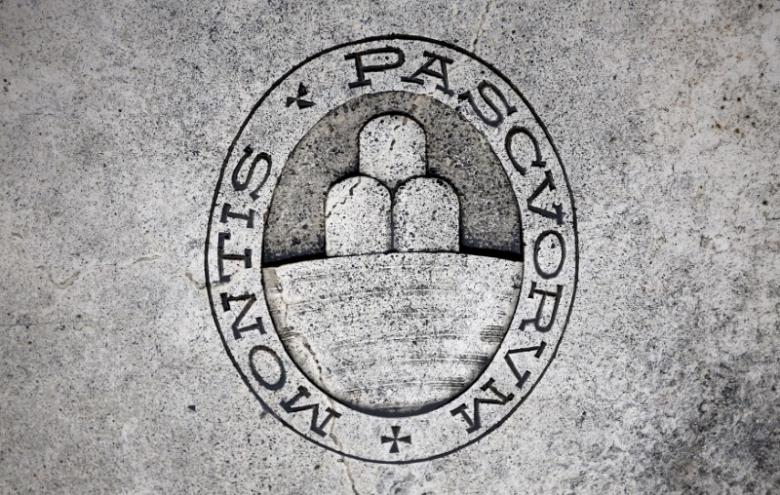 A logo of Monte dei Paschi di Siena bank is seen on the ground in Siena, Italy, November 5, 2014. REUTERS/Giampiero Sposito/File Photo