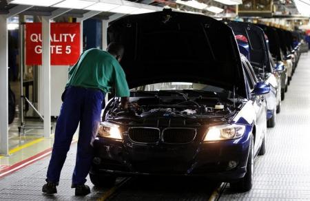 A worker inspects cars at BMW's manufacturing plant in Rosslyn, outside Pretoria,  file. REUTERS/Siphiwe Sibeko