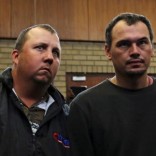 Theo Martins and Willem Oosthuizen (R) appear in court after an online video emerged showing them pushing a black man into a coffin and threatening to burn him alive, at the Middelburg magistrates High Court, in Mpumalanga province, South Africa, November 16, 2016. REUTERS/Siphiwe Sibeko