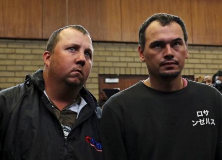 Theo Martins and Willem Oosthuizen (R) appear in court after an online video emerged showing them pushing a black man into a coffin and threatening to burn him alive, at the Middelburg magistrates High Court, in Mpumalanga province, South Africa, November 16, 2016. REUTERS/Siphiwe Sibeko